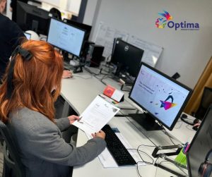 Image shows Optima UK recruitment consultant Sandra Kokowicz at her desk and looking through CVs.