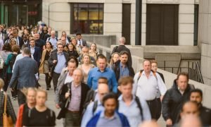 a crowd of business people in a rush to get to work - representing the UK real-life workforce and UK labour market