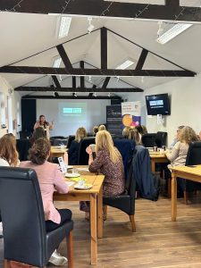 People sat listening to a speaker at the Worcestershire Workplace Wellbeing at Work Well Live Better Showcase delivered by Optima UK